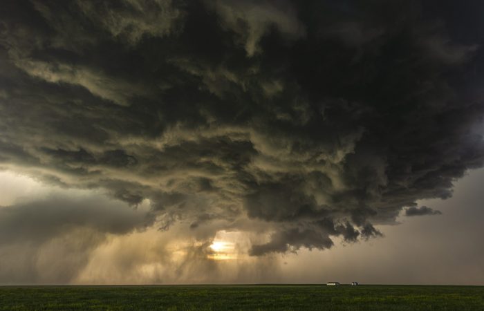 Sunset with extreme weather, this tornado-warned thunderstorm, the dark wall cloud hangs low close to the ground while it rotates, Taken near Judith Gap, Montana, tornado alley USA.