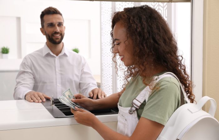African,American,Woman,With,Money,At,Cash,Department,Window,In
