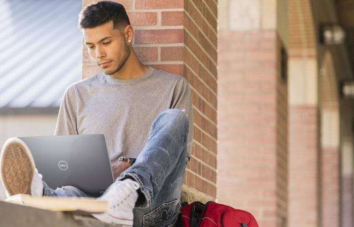 Student Working on a Laptop on campus, Education